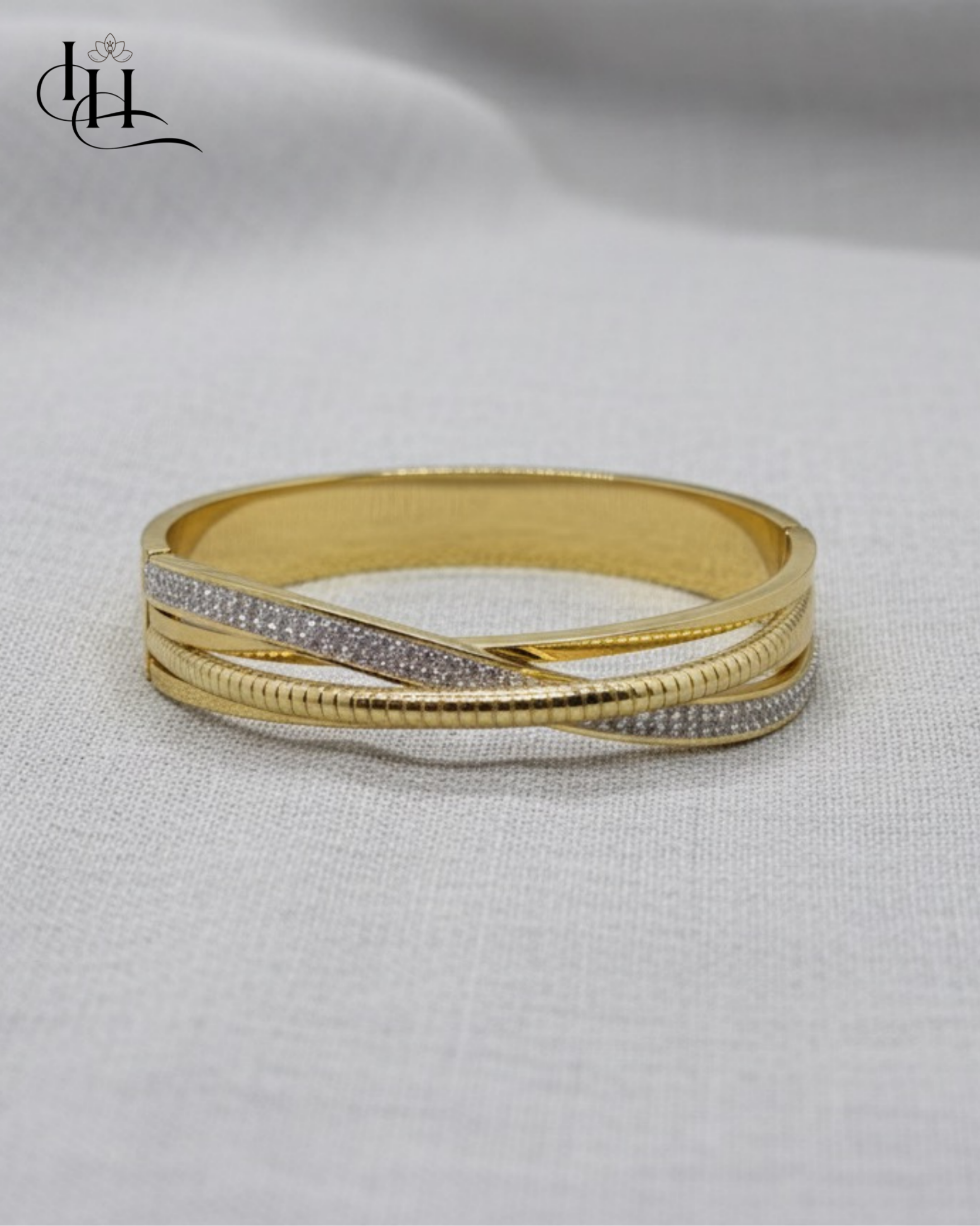 Elegant Dual-Tone Crossover Gold and Diamond Bangle